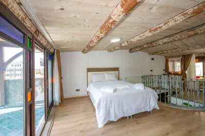 a bedroom with a bed and a large window at Taksim Antique Hotel in Istanbul