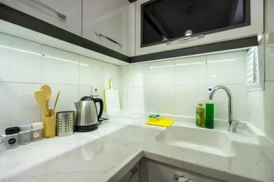 a kitchen with white counter tops and a sink at Blue Mosq- Three Storey Detached Villa in Istanbul