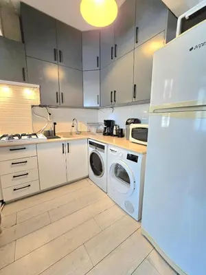 a kitchen with a refrigerator and a washer and dryer at Osmanbey sweet homes in Istanbul
