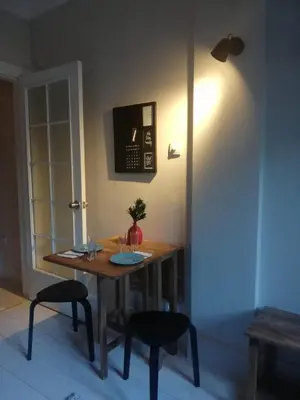 a dining room table with two chairs and a light at Osmanbey sweet homes in Istanbul