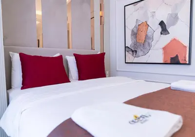 a bedroom with a large white bed with red pillows at Cetin Port Hotel in Istanbul