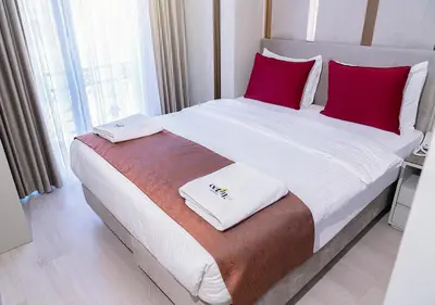 a bedroom with a large bed with red pillows at Cetin Port Hotel in Istanbul