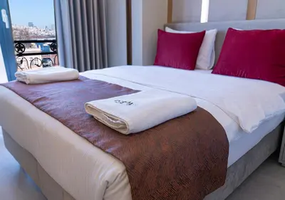 a bed with two towels on top of it at Cetin Port Hotel in Istanbul