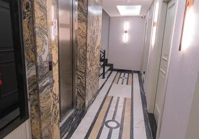 a hallway with a tile floor in a building at Cetin Port Hotel in Istanbul