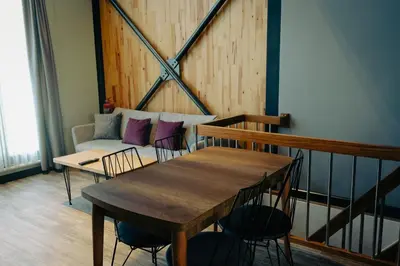 a table and chairs in a room with a couch at Kartepe LOFT in Kartepe