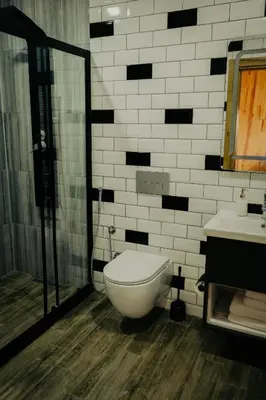 a bathroom with a toilet and a shower and a sink at Kartepe LOFT in Kartepe