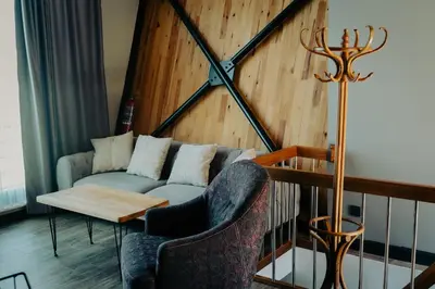 a living room with a couch and two chairs at Kartepe LOFT in Kartepe