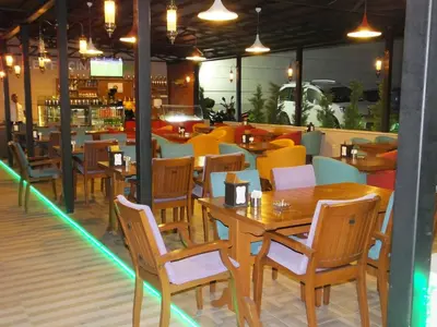 a dining room with wooden tables and chairs at Çınarpark Hotel in Korfez