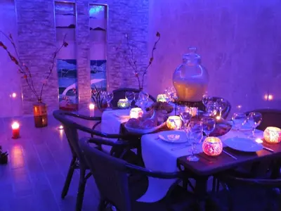 a long table with candles and a large vase on it at Çınarpark Hotel in Korfez