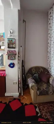 a living room with a couch and a refrigerator at Nur home 2 in Istanbul