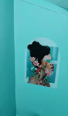 a picture of a girl with flowers on a shelf at Nur home 2 in Istanbul