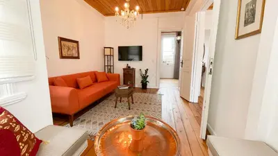 a living room with an orange couch and a table at Stanbul House in Istanbul