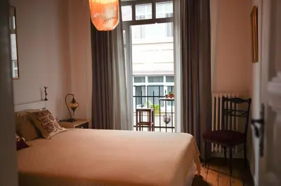 a bedroom with a bed and a large window at Stanbul House in Istanbul