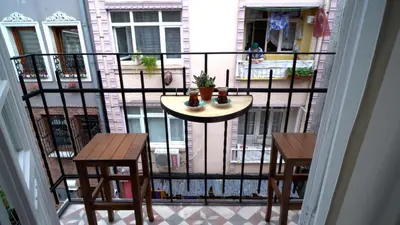 a balcony with a table and two chairs on a balcony at Stanbul House in Istanbul