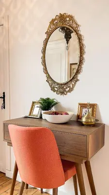 a mirror sitting on top of a wooden table with a chair at Stanbul House in Istanbul