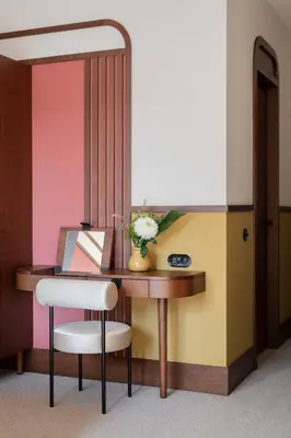 a desk with a vase of flowers and a mirror at GentleTom in Istanbul