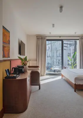 a hotel room with a bed and a large window at GentleTom in Istanbul