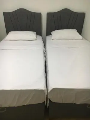two beds sitting next to each other in a room at Canan’s apartment in Istanbul