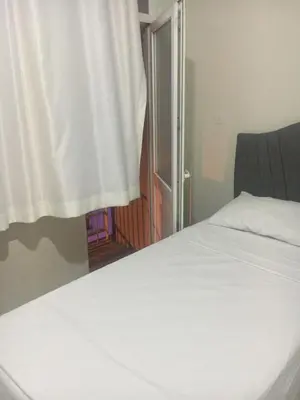a bedroom with a white bed and a window at Canan’s apartment in Istanbul