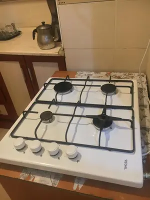 a white stove top with four burners on it at Canan’s apartment in Istanbul