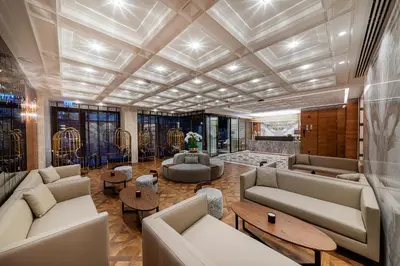 a large living room with couches and tables at Mukarnas Pera Hotel in Istanbul