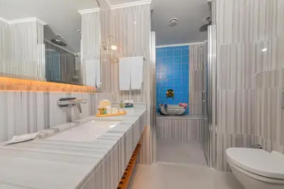 a white bathroom with a sink and a toilet at Mukarnas Pera Hotel in Istanbul