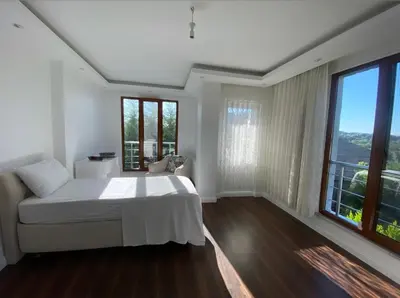 a white bedroom with a bed and a large window at Wonderful Villa Airport 5 minutes in Arnavutköy