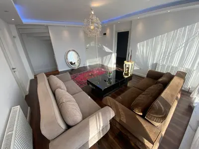 a living room with a couch and a table at Wonderful Villa Airport 5 minutes in Arnavutköy