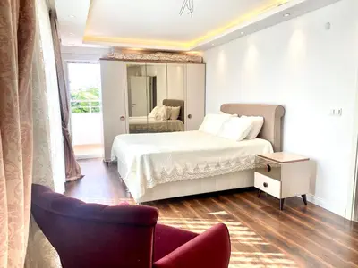 a bedroom with a bed and a chair and a mirror at Wonderful Villa Airport 5 minutes in Arnavutköy