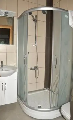 a shower with a glass door in a bathroom at Mola Hotel in Marmara Adasi