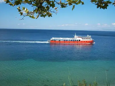 a large red and white boat on the water at Mola Hotel in Marmara Adasi