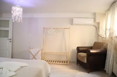 a bedroom with a chair and a bed and a chandelier at Pink OLD CITY 1 in Istanbul