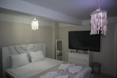 a bedroom with a white bed and a television at Pink OLD CITY 1 in Istanbul