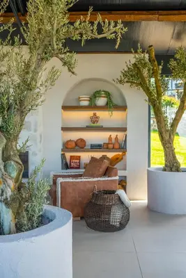 a living room with two potted trees and a couch at Alya Kartepe Villa Hotel in Kocaeli