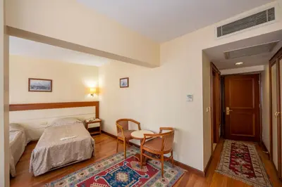 a bedroom with a bed and a desk and a table at Hotel Erdal in Istanbul