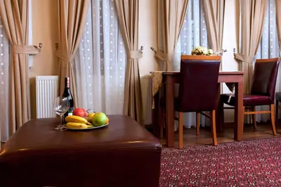 a table with a plate of fruit and a bottle of wine at Sultanahmet Suites in Istanbul