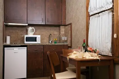 a small kitchen with a table and a microwave at Sultanahmet Suites in Istanbul