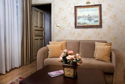 a living room with a couch and a table with flowers at Sultanahmet Suites in Istanbul