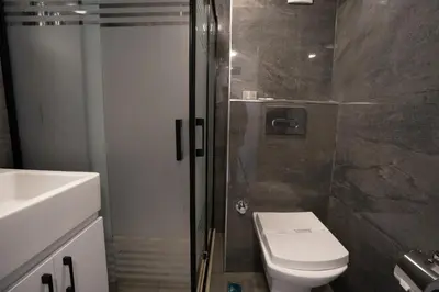 a bathroom with a shower and a toilet and a sink at Navoris Hotel in Istanbul