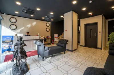 a lobby with two chairs and a counter in a store at Navoris Hotel in Istanbul