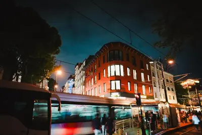 a bus is driving down a city street at night at Navoris Hotel in Istanbul