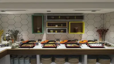 a counter with many plates of food on it at Holiday Inn Istanbul Old City by IHG in Istanbul