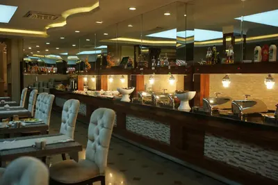 a restaurant with a bar with chairs and tables at Hotel Sapphire in Istanbul