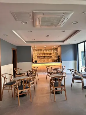 a room with tables and chairs and a bar at Hotel Sapphire in Istanbul