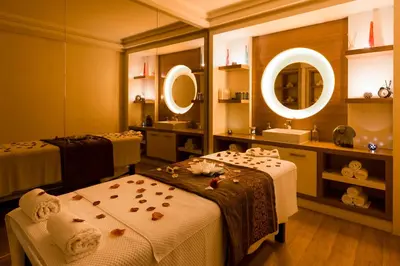 a bathroom with two beds and a sink and mirrors at Sirkeci Mansion in Istanbul
