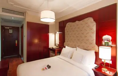 a bedroom with a large white bed and two lamps at Sirkeci Mansion in Istanbul