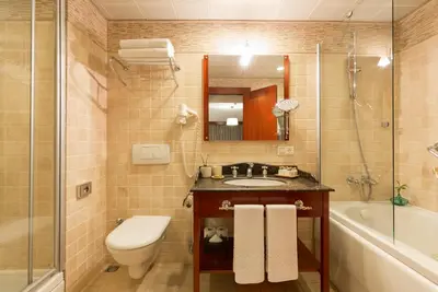 a bathroom with a sink and a toilet and a shower at Sirkeci Mansion in Istanbul