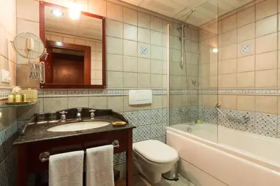 a bathroom with a sink and a toilet and a tub at Sirkeci Mansion in Istanbul