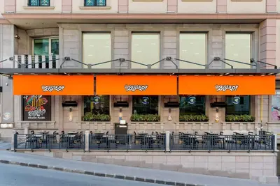 a restaurant with tables and chairs in front of a building at Ramada Plaza By Wyndham Istanbul City Center in Istanbul