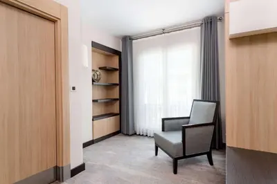 a room with a chair and a window at Ramada Plaza By Wyndham Istanbul City Center in Istanbul